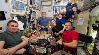 The current six-member Expedition 60 crew gather for dinner inside the galley of the Zvezda service module. When Al Mansouri, Meir and Skripochka arrive there will be nine on the station for eight days. The station's maximum capacity is 12 astronauts. Courtesy: Nasa