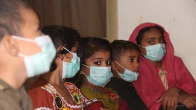 Children sit in an awareness session about Covid-19, on Universal Children's Day, organised by Society for the Protection of the Rights of Child (SPARC) in Hyderabad, Pakistan. EPA