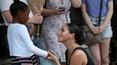 The royal greets a girl outside the organisation's headquarters. Reuters