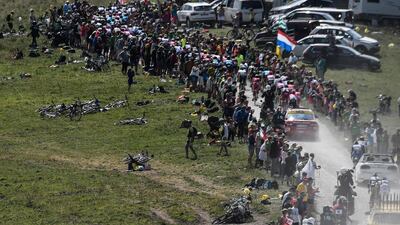 Cyclists ride in the ascent of the Plateau des Glieres during the 10th stage of the Tour de France between Annecy and Le Grand-Bornand. Jeff Pachoud / AFP