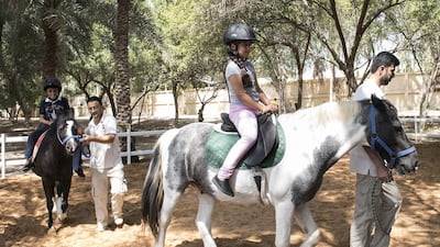 Children enjoy riding in the paddock at the Royal Stables in Abu Dhabi as part of a diabetes awareness programme to help youngsters understand the importance of physical activity and diet in maintaining their well-being. Vidhyaa for The National