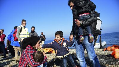 A Syrian family on the Greek island of Lesbos after crossing the Aegean Sea from Turkey with other refugees and migrants, on November 19, 2015. AFP
