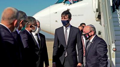 A handout picture released by the US Embassy in Morocco, shows US Presidential advisor Jared Kushner (C) and Israeli National Security Advisor Meir Ben Shabbat (R) greeting officials in Morocco's capital Rabat, upon landing of the first Israel-Morocco direct commercial flight, marking the latest US-brokered diplomatic normalisation deal between the Jewish state and an Arab country. AFP
