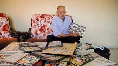 Palestinian man Mahmoud Kayed displays postage stamps which he collected over decades, in the town of Sebastia near Nablus in the Israeli-occupied West Bank. Reuters