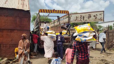 Men load Ethiopian products onto a truck in Sudan's border town of Gallabat on August 2. Photo: AFP