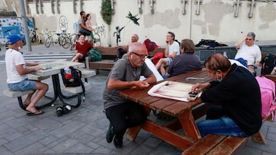 People relax in Tel Aviv, after the Israeli authorities announced that face masks for Covid-19 prevention were no longer needed outside. AFP