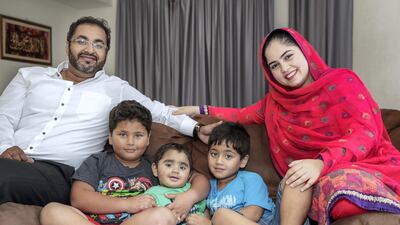 The Peracha family pictured in their home in Abu Dhabi. Haider, 7, (second left) donated bone marrow for his youngest brother Hamza, (centre) who is about to have his first birthday. Also pictured: Uzair Peracha (left), Mustafa, 5, (second right) and Maria Uzair (far right). Victor Besa / The National