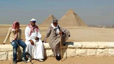 Souvenir salesmen and camel owners wait for tourists at the pyramids in Giza. Marwan Naamani / AFP