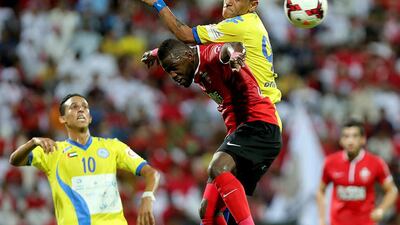 Ismail Al Hamadi of Al Ahli, left, and Jose Rogerio of Al Dhafra in action during their Arabian Gulf League match at the Rashid Stadium in Dubai. Satish Kumar / The National