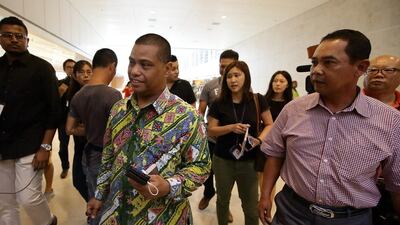 Staff from the Indonesian embassy leave a holding area for friends and relatives of passengers on AirAsia flight QZ8501 at Changi Airport. AirAsia announced that the flight from Surabaya, Indonesia to Singapore lost contact with air traffic control on this morning. Suhaimi Abdullah / Getty Images