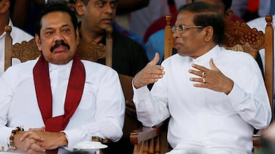 Sri Lanka's newly appointed Prime Minister Mahinda Rajapaksa and President Maithripala Sirisena talk during a rally near the parliament in Colombo, Sri Lanka November 5, 2018. Reuters