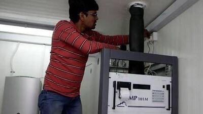 Mohammed Minhaj an air quality technician monitor a air quality station on Hamdan and Muroor Roads in Abu Dhabi November 22, 2012.