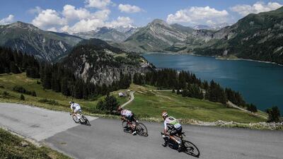 France's Elie Gesbert, Colombia's Darwin Atapuma and Belgium's Serge Pauwels ride down past the Roselend Lake during their breakaway in the eleventh stage of the Tour de France. Philippe Lopez / AFP