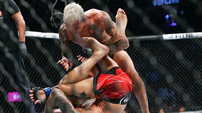 Charles Oliveira, top, pounds Dustin Poirier. AP Photo