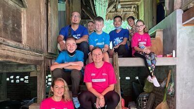 Jennifer Gillespie, left, and Carlotta Rosa, right, with their families in Vietnam. Photo: Jennifer Gillespie
