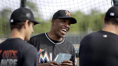 Miami Marlins hitting coach Barry Bonds laughs as he chats with players during spring training baseball practice Monday, Feb. 22, 2016, in Jupiter, Fla. (AP Photo/Jeff Roberson)