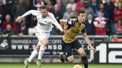 Arsenal's Laurent Koscielny in action with Swansea City's Gylfi Sigurdsson. (Reuters)