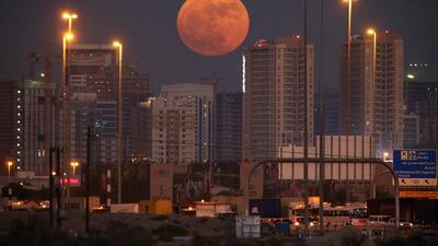 The supermoon rises over residential building in Dubai Sports City. Pawan Singh / The National