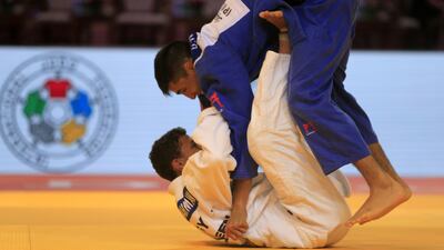 Denislar Ivanov, in blue from Bulgaria, fights with Ahmed Abelrahman from Egypt on the opening day of the International Judo Federation (IJF) Junior World Championships, which started at the Ipic Arena at the Zayed Sports City in Abu Dhabi on Friday. Ravindranath K / The National