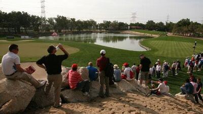 Fans line the 12th green to watch Rory Mcilroy, Paul Casey and Miguel Angel Jimenez at the Abu Dhabi HSBC Golf Championship.