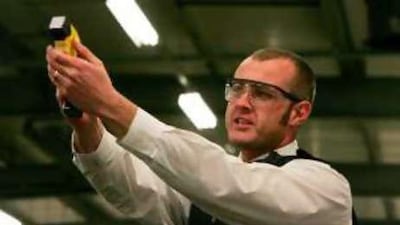 A police officer shoots a Taser gun at the Metropolitan Police Specialist Training Centre in Kent, south-east England.