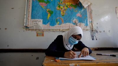 A Yemeni student wearing a protective face mask takes final school exams, after five months of closure due to the coronavirus pandemic, at a public school in Sanaa, Yemen. EPA