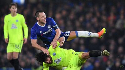 John Terry fouls Ryan Tafazolli of Peterborough United. Shaun Botterill / Getty Images