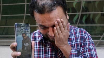 A relative weeps while showing the picture of Sohail Shahid, a Pakistani citizen who was killed in Christchurch mosque shootings. AP Photo