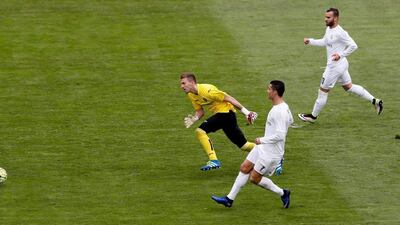 Real Madrid’s Portuguese striker Cristiano Ronaldo (C) scores his goal next to goalkeeper Vicente Guaita (L) of Getafe FC during their La Liga match played at Coliseum Alfonso Perez stadium in Getafe, Madrid, Spain on 15 April 2016. EPA/JuanJo Martin
