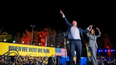 Ms Harris and her running mate, Democratic vice presidential nominee Tim Walz, greet supporters in Ann Arbor, Michigan. AFP