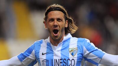 Malaga's Argentinian defender Martin Demichelis celebrates after scoring during the Spanish league football match Malaga CF vs Celta de Vigo on January 19, 2013 at Rosaleda stadium in Malaga. AFP PHOTO/ JORGE GUERRERO