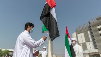 Pupils also raised UAE flags. Antonie Robertson / The National