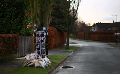 Floral tributes and photographs at the spot in Hale Barns where Yousef was stabbed to death. Reuters