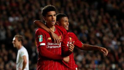 Ki-Jana Hoever, 17, celebrates Liverpool's second goal with another teenager, 19-year-old Rhian Brewster. Reuters