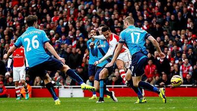 Alexis Sanchez scores the team's second goal weaving past three defenders for a tight finish against Stoke City at the Emirates Stadium. Julian Finney / Getty Images
