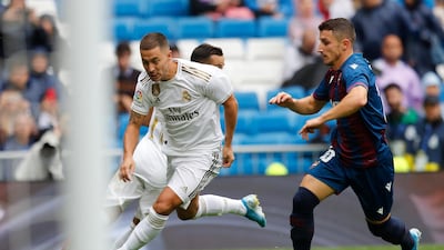 Real Madrid's Eden Hazard, left, vies for the ball with Levante's Enis Bardhi. AP Photo