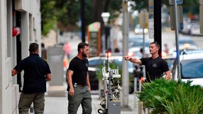 Bomb squad police prepare a robot to enter a parking garage a block away from the scene of a multiple shooting at the Jacksonville Landing. AP Photo