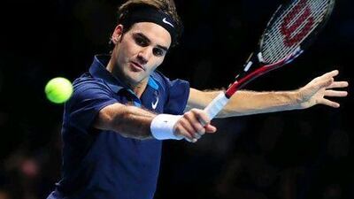 Roger Federer of Switzerland plays a backhand volley in a match against Jo-Wilfried Tsonga of France during the ATP World Tour Finals tennis tournament in London on November 2011.