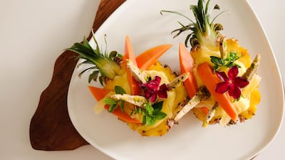 A pineapple bowl with lime, papaya, mango, coconut cookies, cranberries. Courtesy Sergio Lopez
