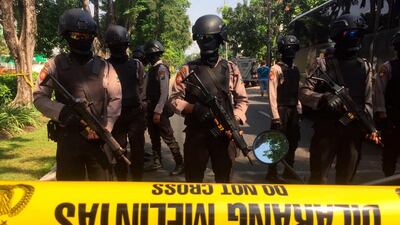 Police officers stand guard near the site where an explosion went off at Santa Maria church in Surabaya, East Java, Indonesia. Trisnadi / AP Photo