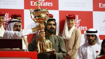 Sheikh Mohammed with the Dubai World Cup trophy at Meydan Racecourse in 2012. Pawan Singh / The National