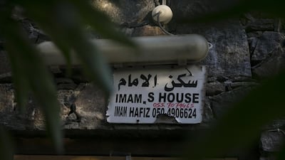 FUJAIRAH, UNITED ARAB EMIRATES, March 1, 2014: A sign announces the name and phone number for the Al Bidya Mosque's imam as seen on Sunday, March 2, 2014, on his home right next to mosque. Al Bidya Mosque, located about 35 km north from Fujairah, is also called the Othmanian mosque. It is the oldest UAE mosque, dating back to 1446 A.D. Ahmad, originally from Bangladesh, has lived in the UAE, working as imam for the past 15 years, 8 of which he's been the Al Bidya imam. He said that he's always dreamed of seeing the world, now, as the imam here, he has the world come to him, as the mosque gets visitors from around the world. (Silvia Razgova / The National)Reporter: Lindsay CarollUsage: March 7, 2014Section: National