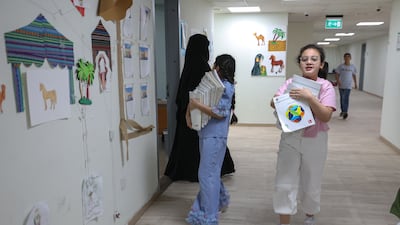 A pupil carries books to the classroom