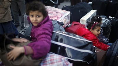 Palestinian children hoping to cross into Egypt wait, surrounded by luggage, at the Rafah crossing between Egypt and the southern Gaza Strip.
