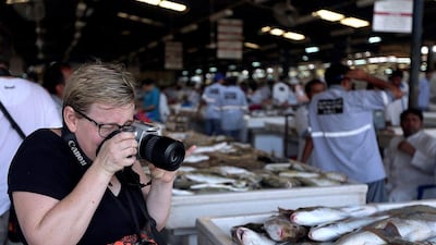 Mari Williams zooms in at the fish market. Satish Kumar / The National