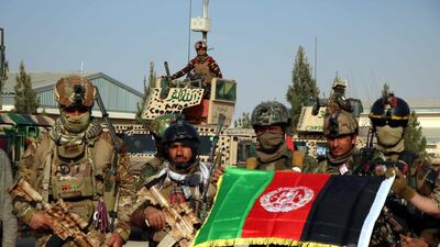 Afghan security officials pose in the Karokh district of Herat after suspected Taliban militants were killed in an attack on Pashtan Dam in Afghanistan on 16 March 2021. At least three Afghan soldiers and eight Taliban militants were killed in the incident. Jalil Rezayee / EPA