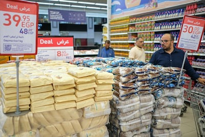A customer checks out prices of discounted rice offers at a supermarket in Cairo. Bloomberg