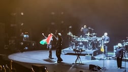 Robert Del Naja and Grant Marshall of the band Massive Attack stand with a Palestinian flag at the end of their performance in Singapore on July 29. Reuters