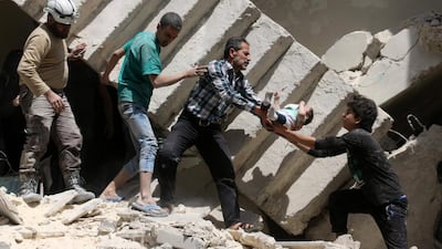 Syrian civil defence volunteers and rescuers remove a baby from under the rubble of a destroyed building following a reported air strike on the rebel-held neighbourhood of Al-Kalasa in the northern Syrian city of Aleppo, on April 28, 2016as the death toll in Syria's second city Aleppo climbed despite a plea by the UN envoy for the warring sides to respect a February ceasefire. Ameer Alhalbi/AFP