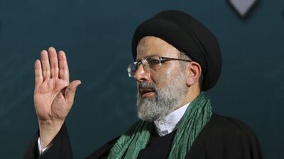 Iranian presidential candidate cleric Ebrahim Raisi waves to his supporters upon arrival at his campaign rally for the May 19 election at Imam Khomeini grand mosque in Tehran. Vahid Salemi / AP Photo